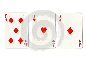 Vintage playing cards showing a pair of aces and a five.