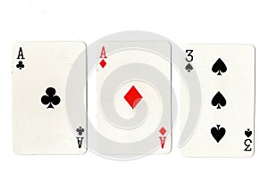 Vintage playing cards showing a pair of aces and a three.