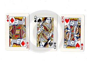 Vintage playing cards showing a pair of pair of kings and a queen.