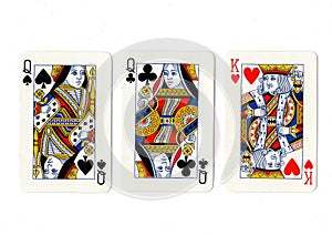 Vintage playing cards showing a pair of pair of queens and a king.