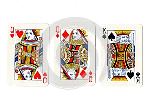 Vintage playing cards showing a pair of pair of queens and a king.