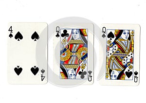 Vintage playing cards showing a pair of queens and a four.