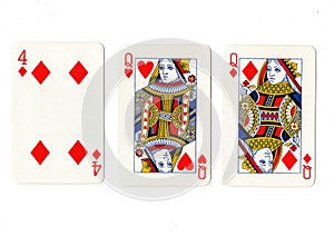 Vintage playing cards showing a pair of queens and a four.