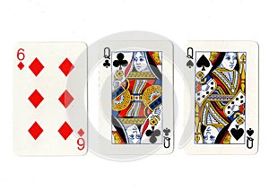 Vintage playing cards showing a pair of queens and a six.