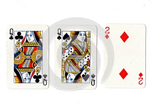 Vintage playing cards showing a pair of queens and a two.