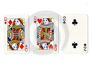 Vintage playing cards showing a pair of queens and a two.