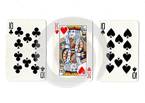 Vintage playing cards showing a pair of tens and a king.