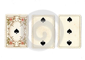 Vintage playing cards showing a run of an ace, two and three of spades.