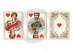 Vintage playing cards showing a run of a queen and king and ace of hearts.