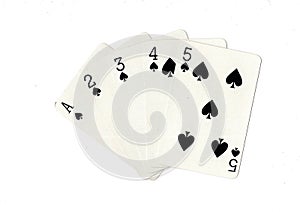 Vintage playing cards showing a run of spades.