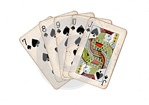 Vintage playing cards showing a run of spades.