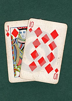 Vintage playing cards showing a ten and jack of diamonds.