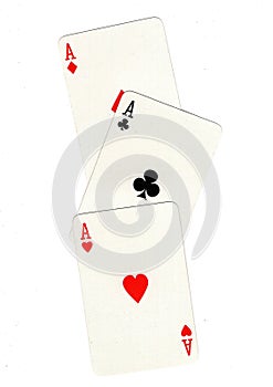 Vintage playing cards showing three aces.