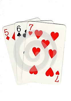 Vintage playing cards showing a three card run in different suits.