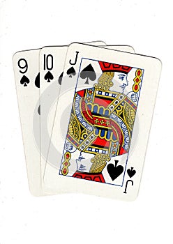 Vintage playing cards showing a three card run of spades.