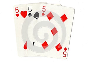 Vintage playing cards showing three fives.