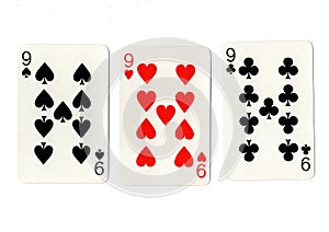 Vintage playing cards showing three nines. photo