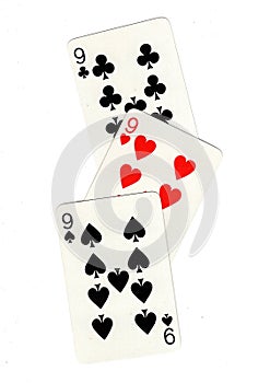 Vintage playing cards showing three nines. photo