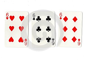Vintage playing cards showing three sixes.