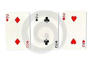 Vintage playing cards showing three twos.