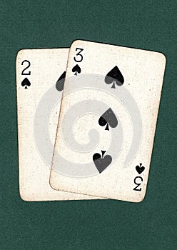 Vintage playing cards showing a two and three of spades.