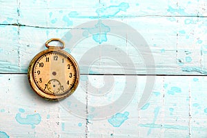 vintage pocket clock on a blue painted wood suraface