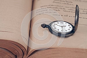 Vintage pocket watch on books.