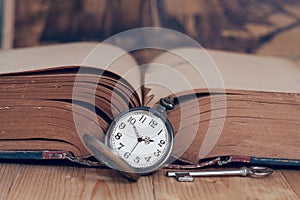 Vintage pocket watch on books.