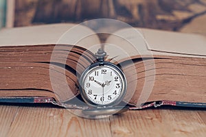 Vintage pocket watch on books.