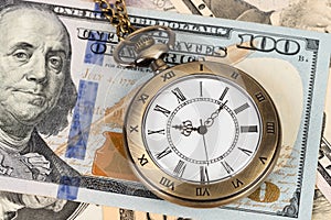 Vintage pocket watch clock on dollar banknote concept for money time value