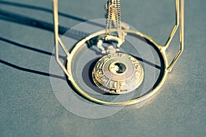 Vintage pocket watch with constelation design on cover shoot in a summer day closeup. Selective Focus