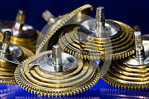 Vintage Pocket Watch Fusee Cones Resting on a Blue Surface