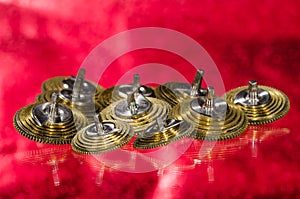 Vintage Pocket Watch Fusee Cones Resting on a Red Surface