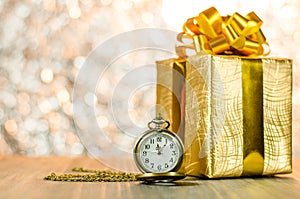 Vintage pocket watch with gold christmas gift box, ribbon and bo
