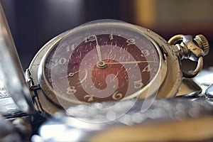 Vintage pocket watch with a red dial in retro style close up