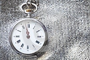 vintage pocket watch on silver fabric background