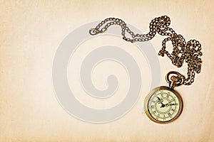 Vintage pocket watch on yellowed paper