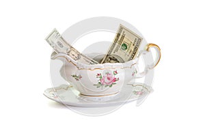 Vintage porcelain sauce-boat with dollar bills