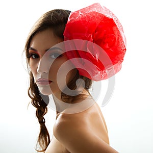 Vintage portrait of fashion glamour girl with red flower in her hair, studio shot