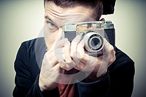 Vintage portrait of fashion guy with old camera