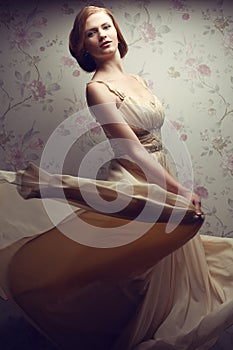 Vintage portrait of happy glamorous red-haired girl in cool dress