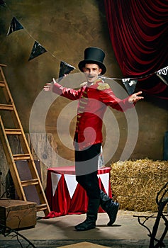 Vintage portrait of male retro circus entertainer expresses rejoice and announces start of show over dark retro circus