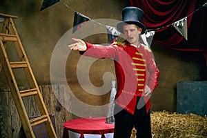 Vintage portrait of male retro circus entertainer expresses rejoice and announces start of show over dark retro circus