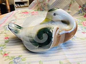 Vintage Pottery Brown Green and White Duck Figurine on Floral Silk Scarf Background