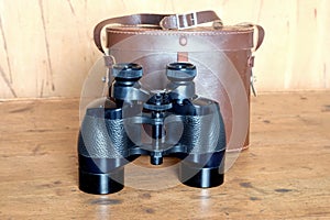 Vintage prism black color binoculars and brown leather case