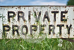 Vintage private property sign in the spring meadow. Close up