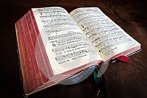 Vintage psalm book with chorus singing notes