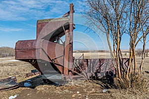 Vintage pull-type combine abandoned in a Saskatchewan, Canada field