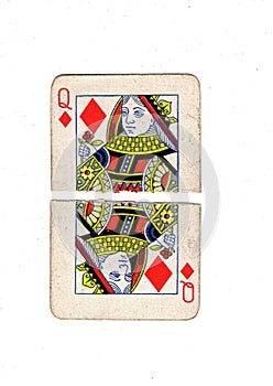 A vintage queen of diamonds playing card torn in half.