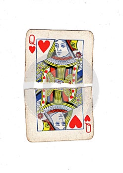 A vintage queen of hearts playing card torn in half.